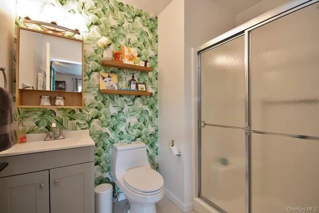 a living room with furniture and a laptop on the desk