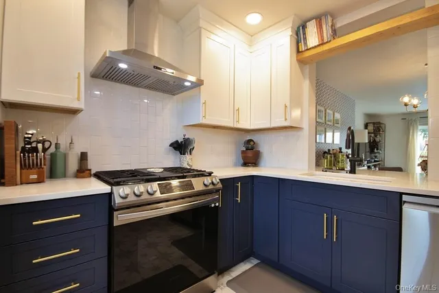 a kitchen with stainless steel appliances granite countertop a sink a stove and a microwave