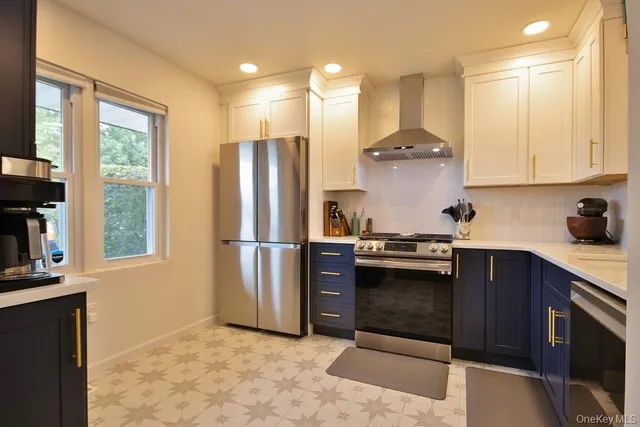 a kitchen with stainless steel appliances a stove a refrigerator and a sink