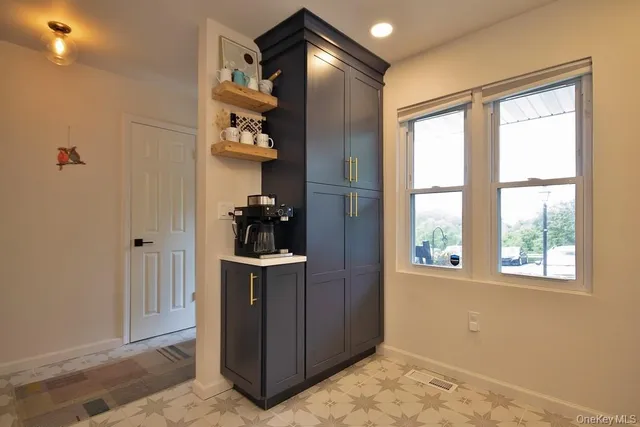 a kitchen with stainless steel appliances granite countertop a stove a refrigerator and a sink