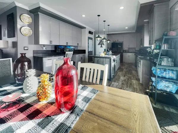 a kitchen with stainless steel appliances kitchen island granite countertop a sink and cabinets