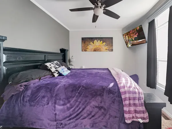 a bed sitting in a bedroom next to a window