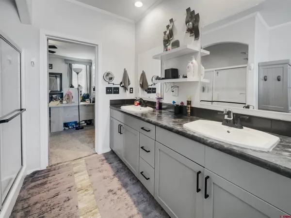 a spacious bathroom with a double vanity sink and a mirror