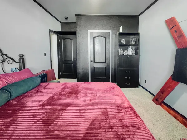 a bedroom with a bed and a dresser