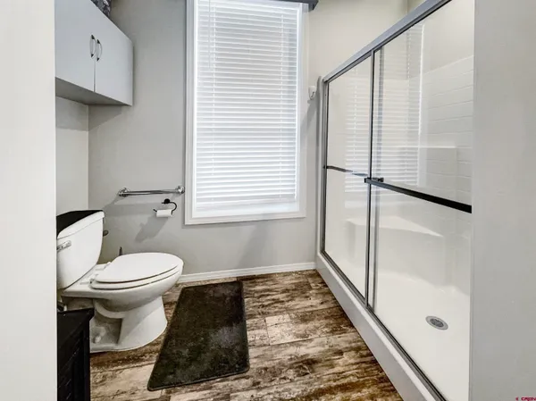a bathroom with a toilet and a shower