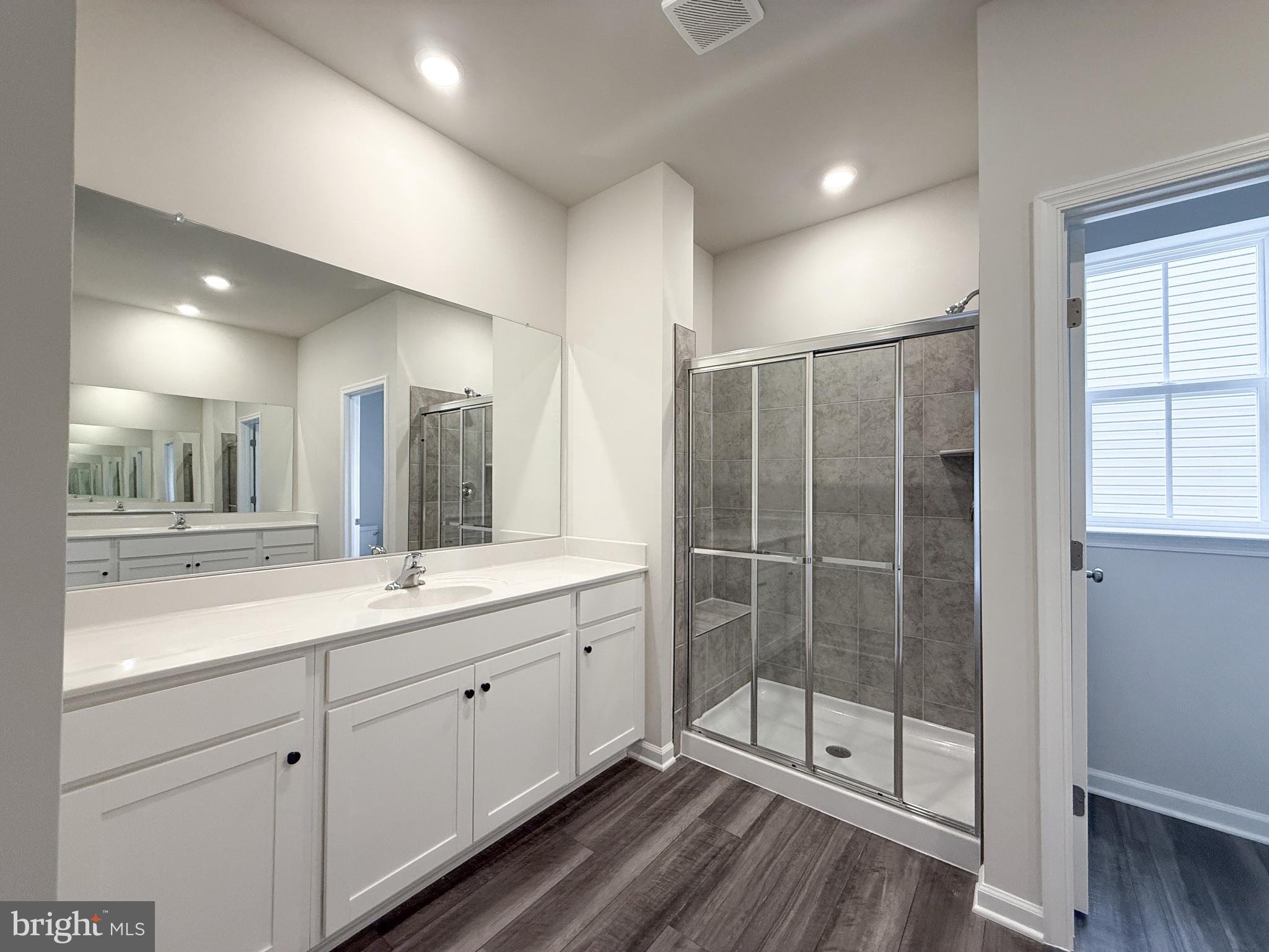 430 Silver Birch Drive Ranson, WV 25438 - Photo 4 of 11 a spacious bathroom with a shower a sink and mirror