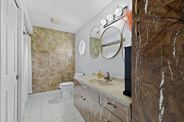 24222 Volbrecht Road Crete, IL 60417 - Photo 10 of 16 a bathroom with a sink a toilet and a shower