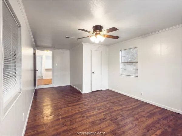 wooden floor in an empty room with a window