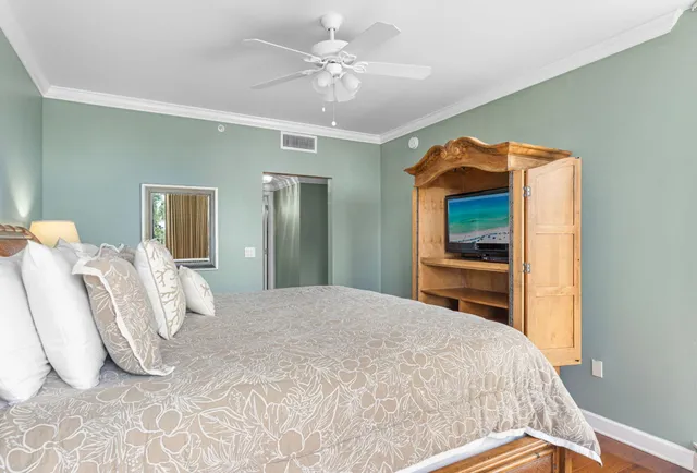 a bedroom with a bed and a chandelier