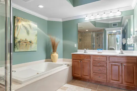 a bathroom with a tub sink and mirror