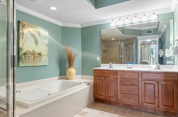 a bathroom with a tub sink and mirror