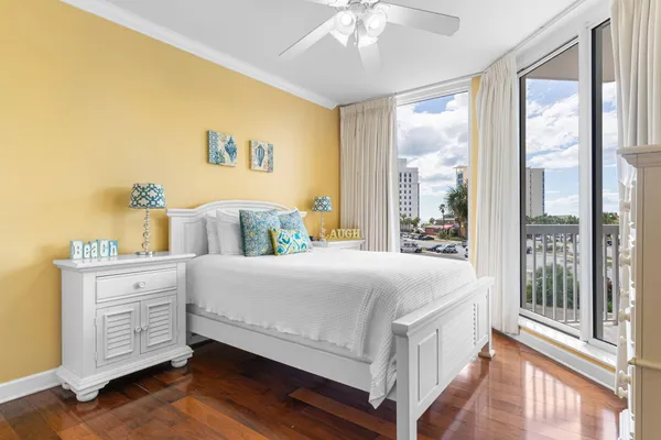 a bedroom with a large bed and a chandelier