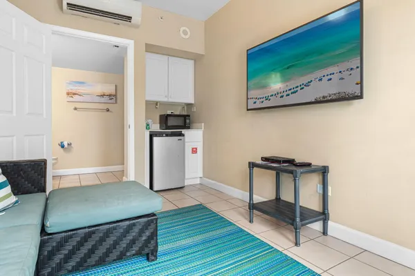 a view of a kitchen with fridge and wooden floor