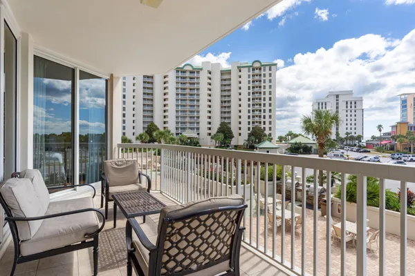 a balcony with furniture and a potted plant