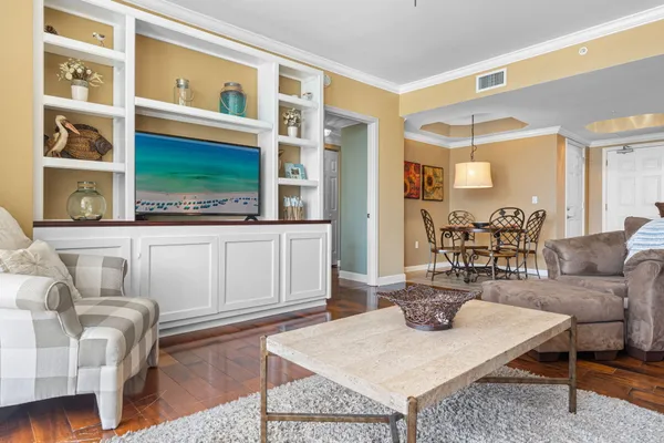 a living room with furniture a rug and a window