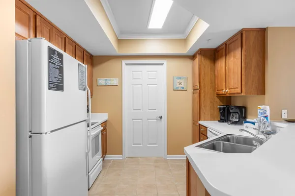 a kitchen with a sink and refrigerator