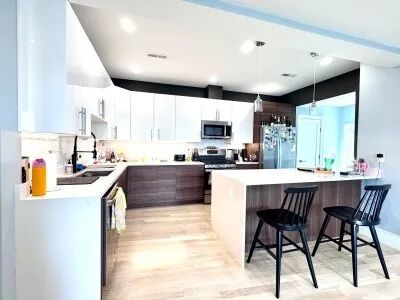 a kitchen with stainless steel appliances kitchen island granite countertop a sink and cabinets