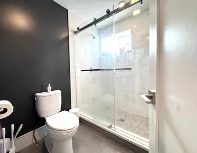 a bathroom with a toilet and a shower
