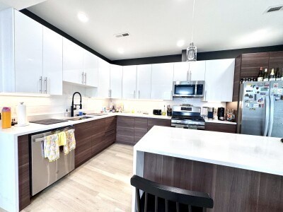9 University Road, Unit 3 Brookline, MA 02445 - Photo 2 of 13 a large kitchen with stainless steel appliances wooden cabinets a sink and a stove