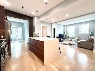 a large white kitchen with a large window