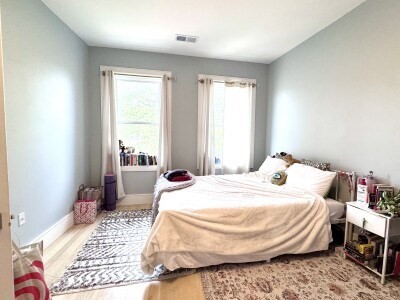 9 University Road, Unit 3 Brookline, MA 02445 - Photo 9 of 13 a bedroom with a bed and wooden floor