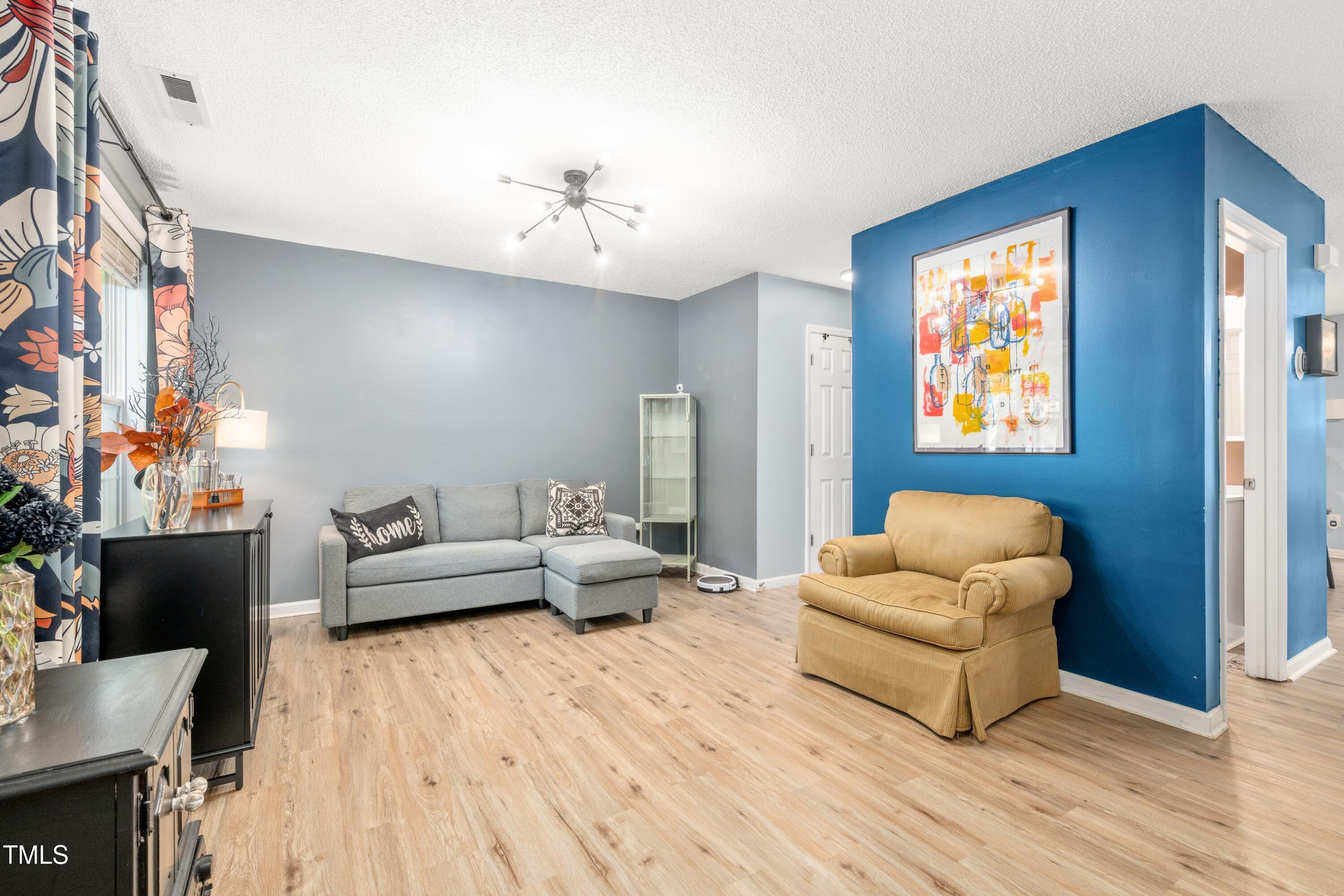 2808 Maple Ridge Drive Durham, NC 27704 - Photo 5 of 22 a living room with furniture and a wooden floor