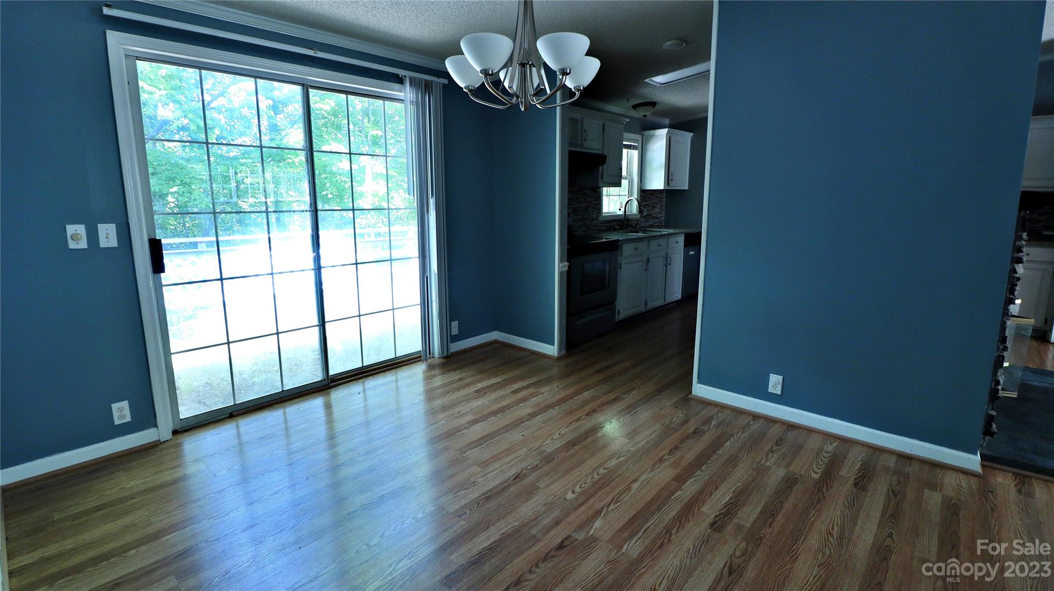 61 Sloan Street Old Fort, NC 28762 - Photo 13 of 38 a view of an empty room with wooden floor and a window