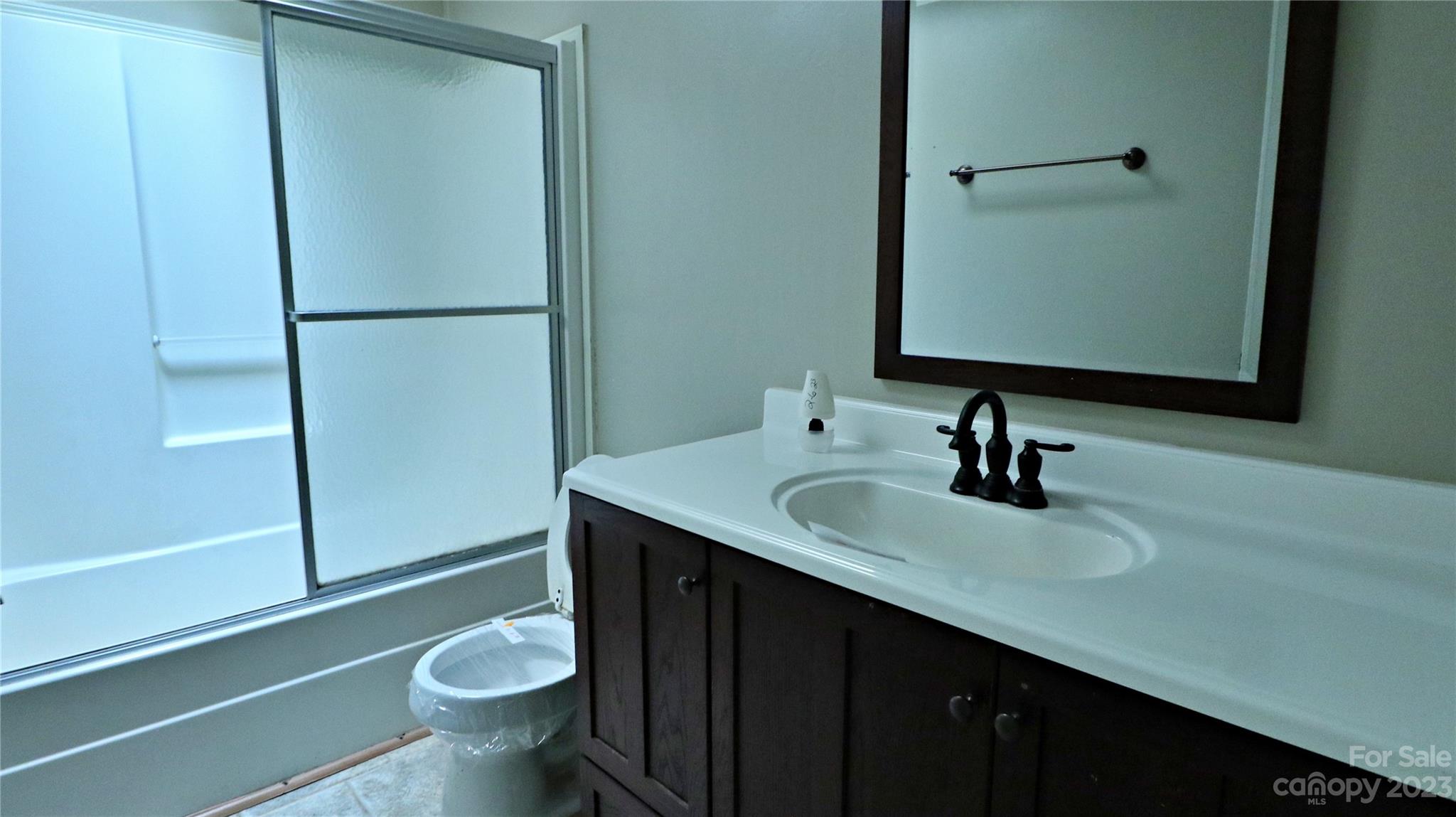61 Sloan Street Old Fort, NC 28762 - Photo 20 of 38 a bathroom with a sink a toilet and a mirror
