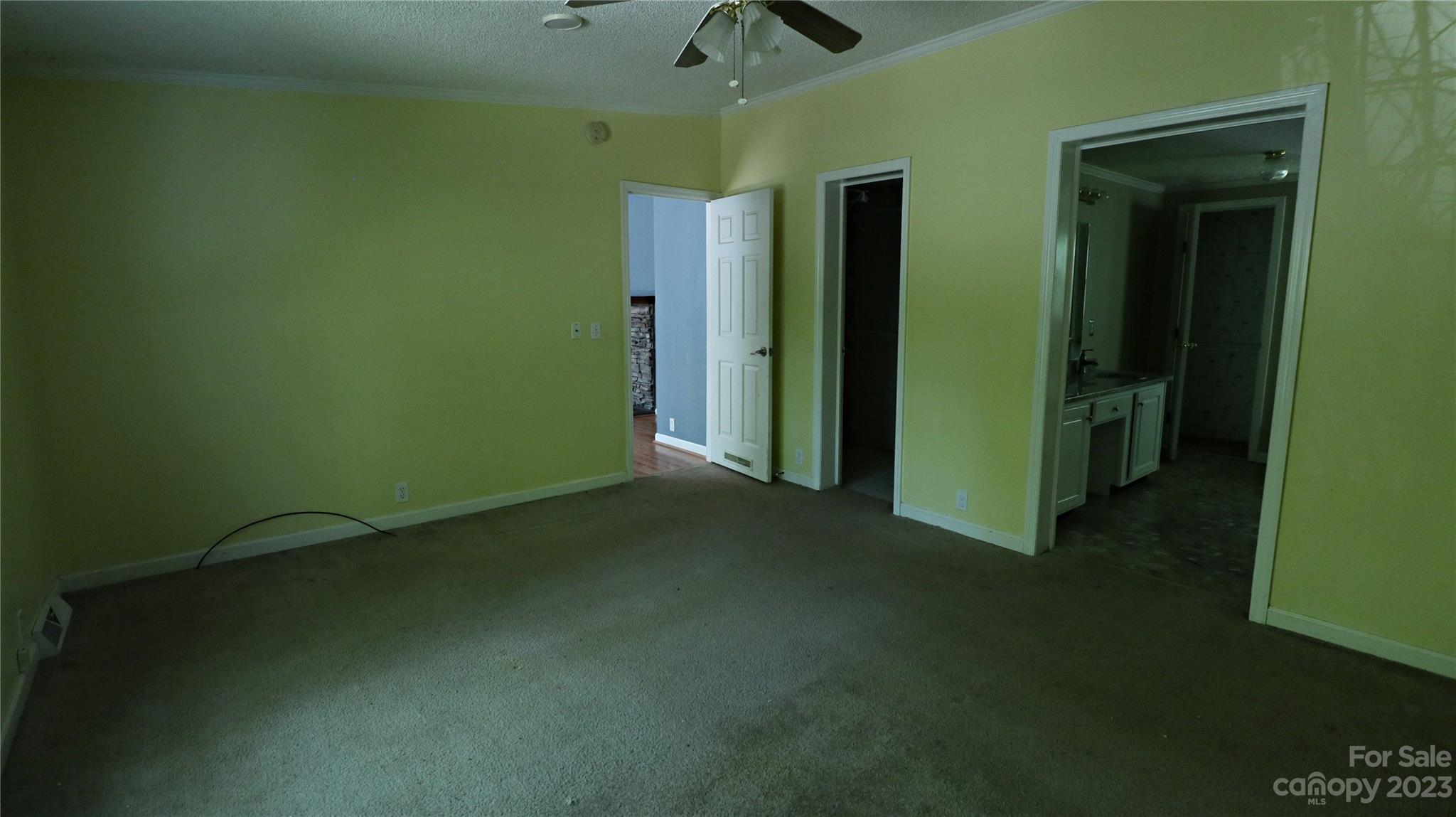 61 Sloan Street Old Fort, NC 28762 - Photo 23 of 38 an empty room with a fan and a window