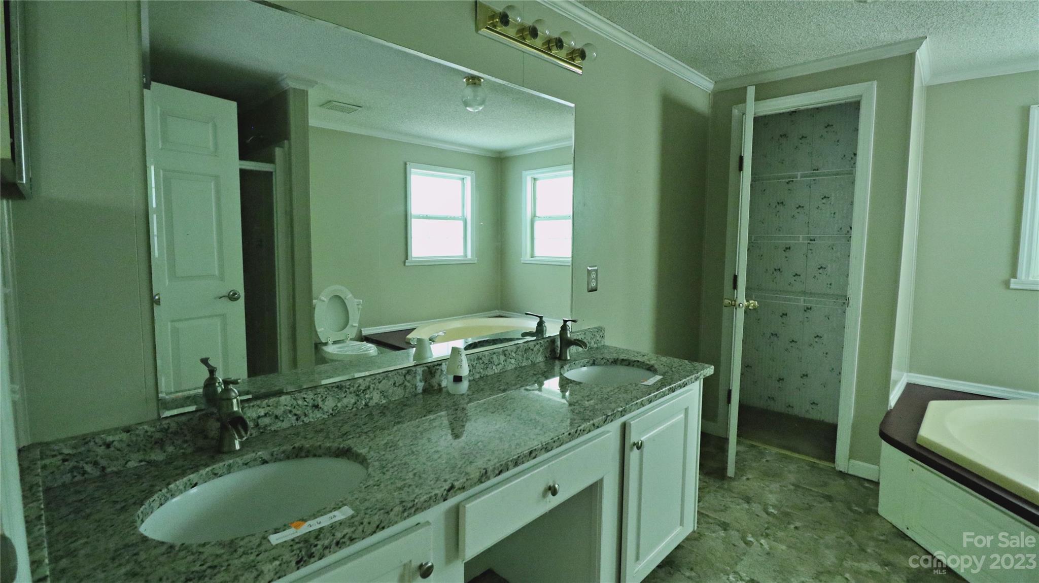 61 Sloan Street Old Fort, NC 28762 - Photo 24 of 38 a bathroom with a granite countertop sink and a mirror