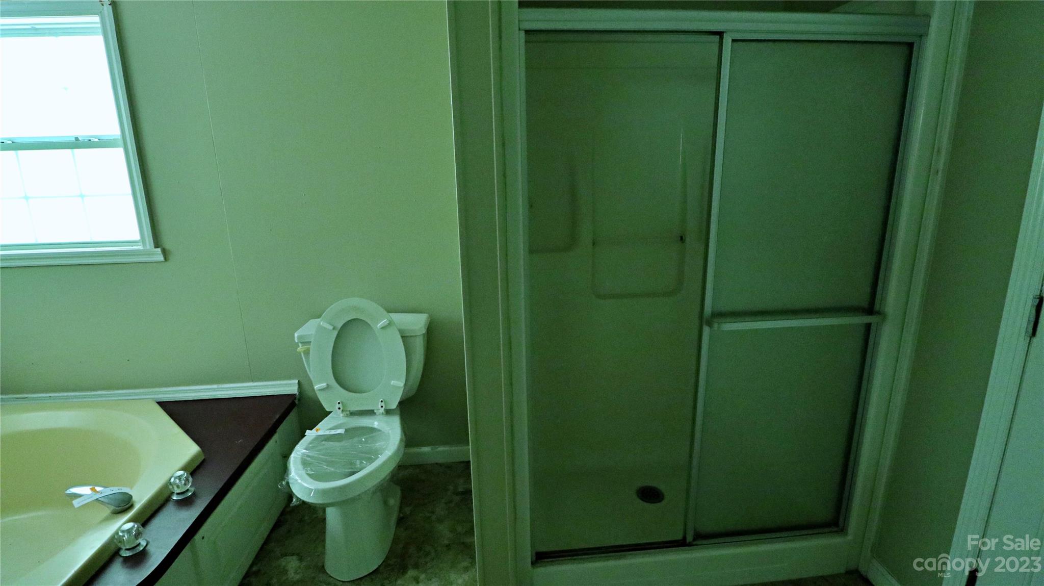 61 Sloan Street Old Fort, NC 28762 - Photo 27 of 38 a bathroom with a toilet and a sink