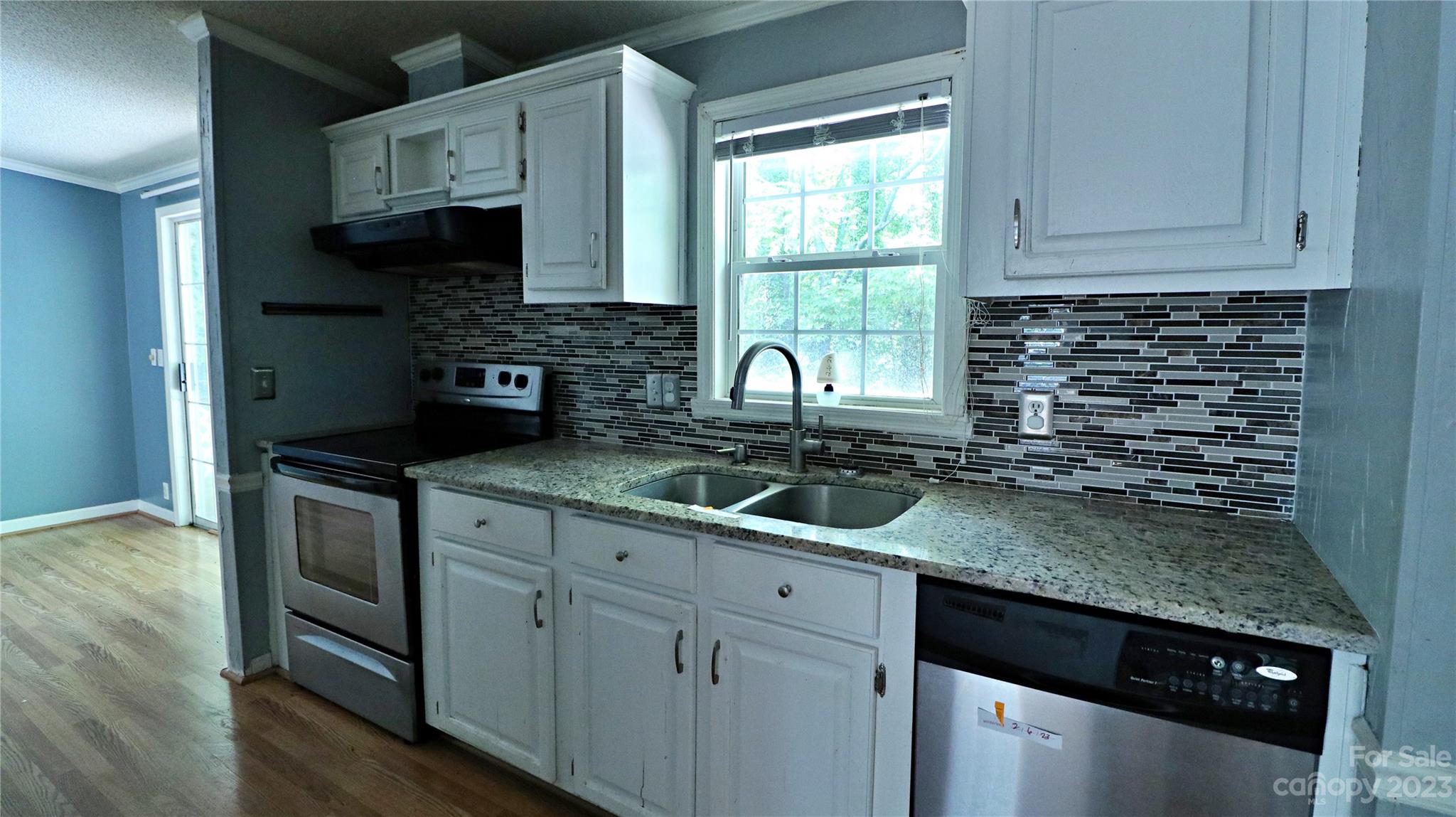 61 Sloan Street Old Fort, NC 28762 - Photo 3 of 38 a kitchen with granite countertop a sink stainless steel appliances and cabinets