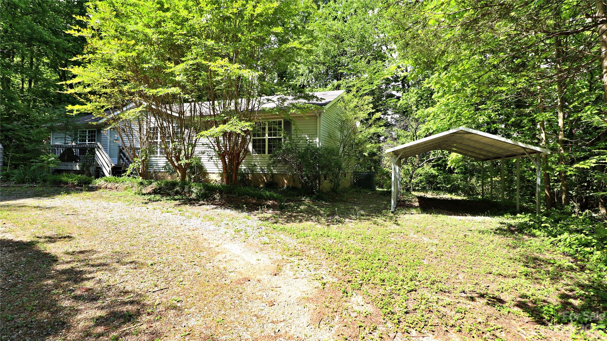 61 Sloan Street Old Fort, NC 28762 - Photo 37 of 38 a backyard of a house with large trees