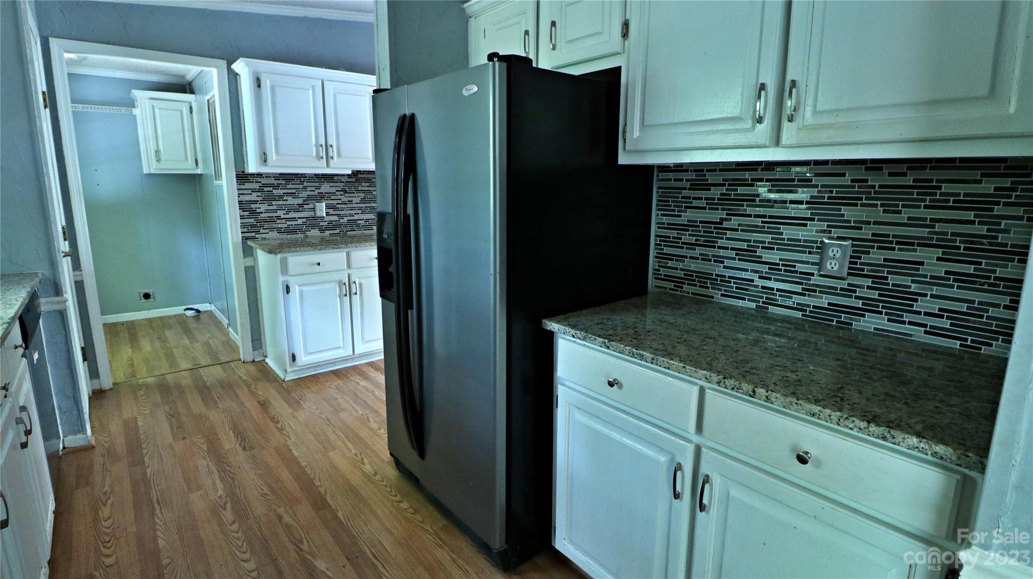 61 Sloan Street Old Fort, NC 28762 - Photo 9 of 38 a kitchen with granite countertop a refrigerator a sink and dishwasher
