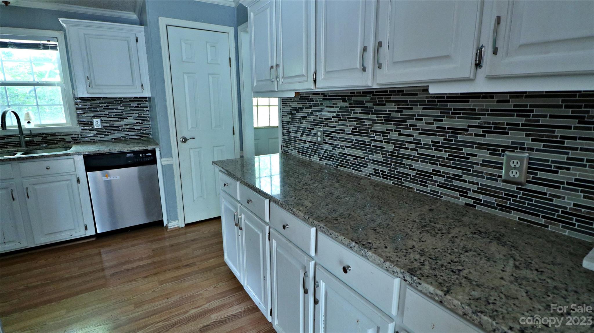 61 Sloan Street Old Fort, NC 28762 - Photo 10 of 38 a kitchen with granite countertop a sink and cabinets