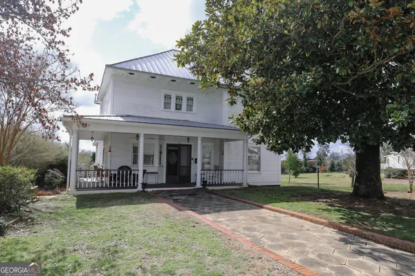 a front view of a house with garden