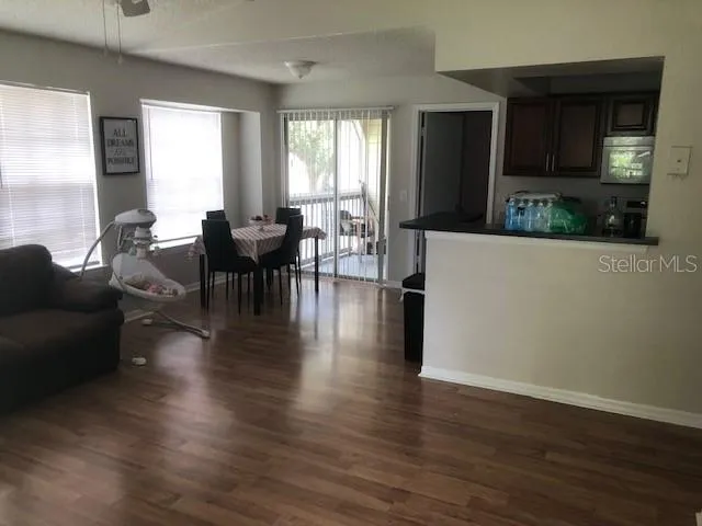 a living room with fireplace furniture and a wooden floor