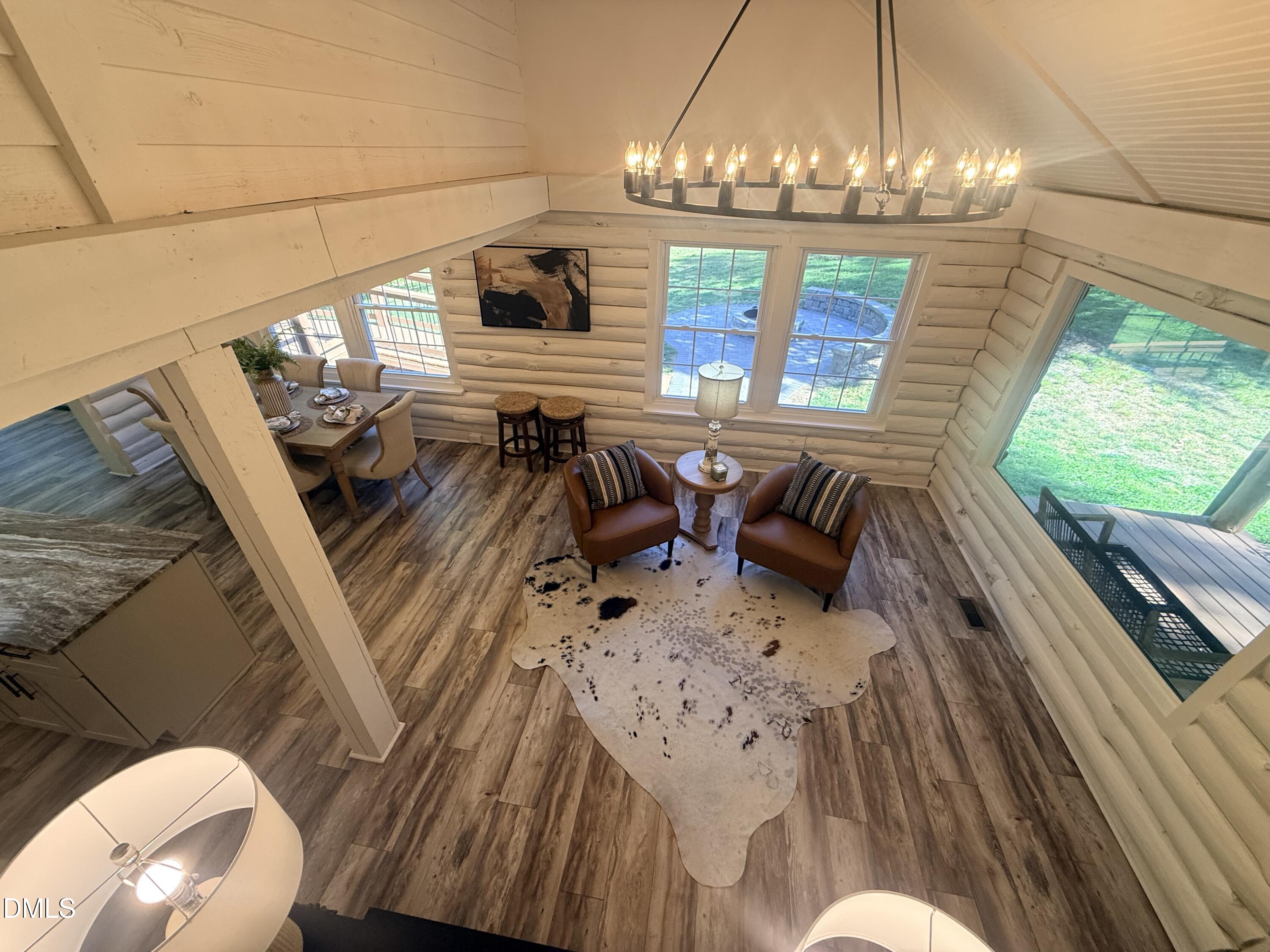 327 Shady Oak Road Roxboro, NC 27574 - Photo 41 of 62 a view of a dining room with furniture wooden floor and chandelier