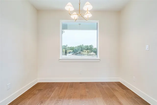 a kitchen with a sink a window and wooden floor