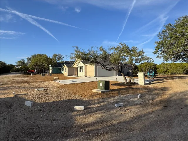 a view of a house with backyard and sitting area