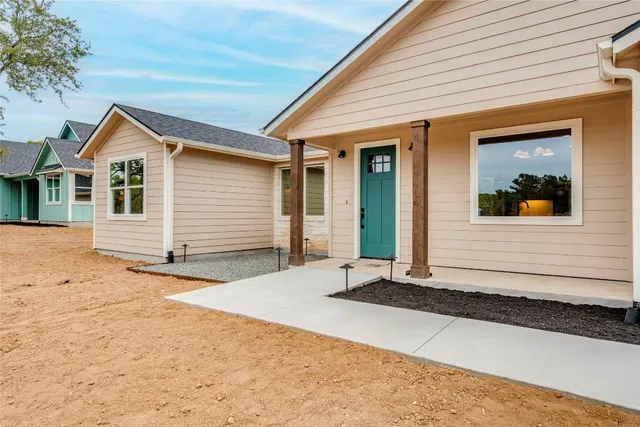 a view of a kitchen with a sink dishwasher and a fireplace