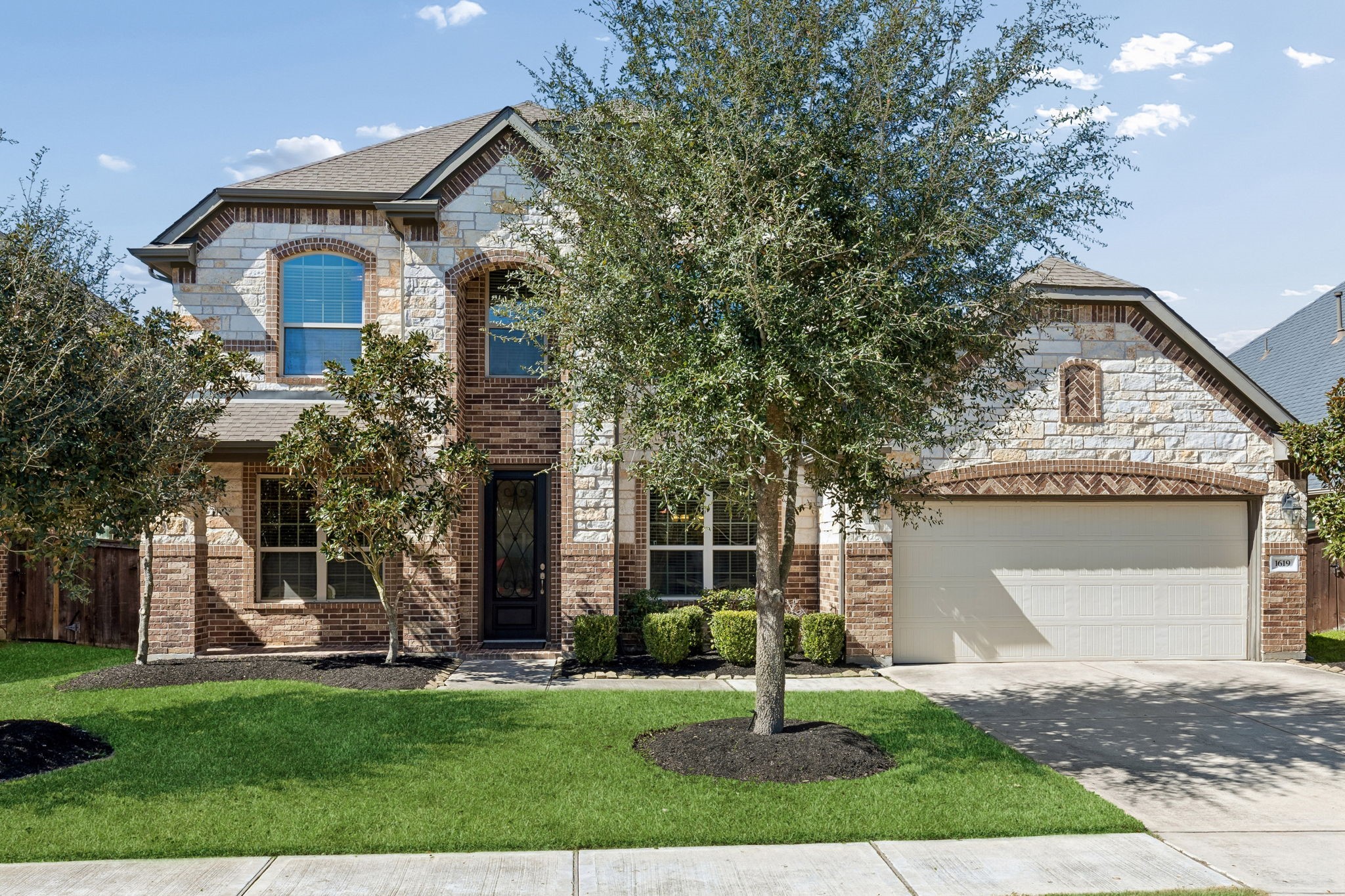 Welcome to 1619 Dove Ridge Drive. This beautiful residence in Cane Island offers exceptional curb appeal with professional landscaping. The two-story design features a striking elevation and a spacious attached garage.