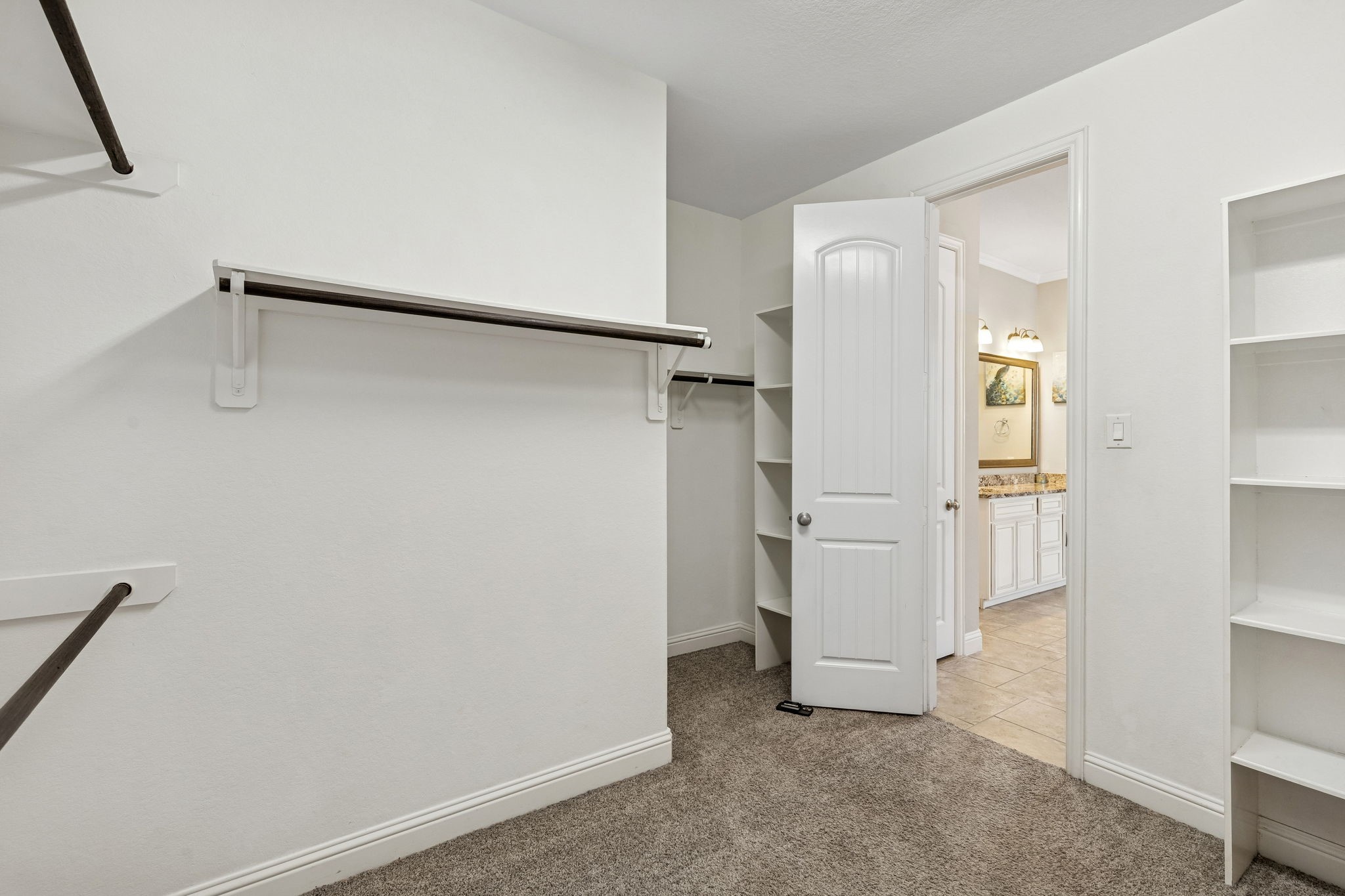 1619 Dove Ridge Drive Katy, TX 77493 - Photo 12 of 28 This massive primary walk-in closet offers extensive built-in shelving and hanging space to keep your wardrobe organized.