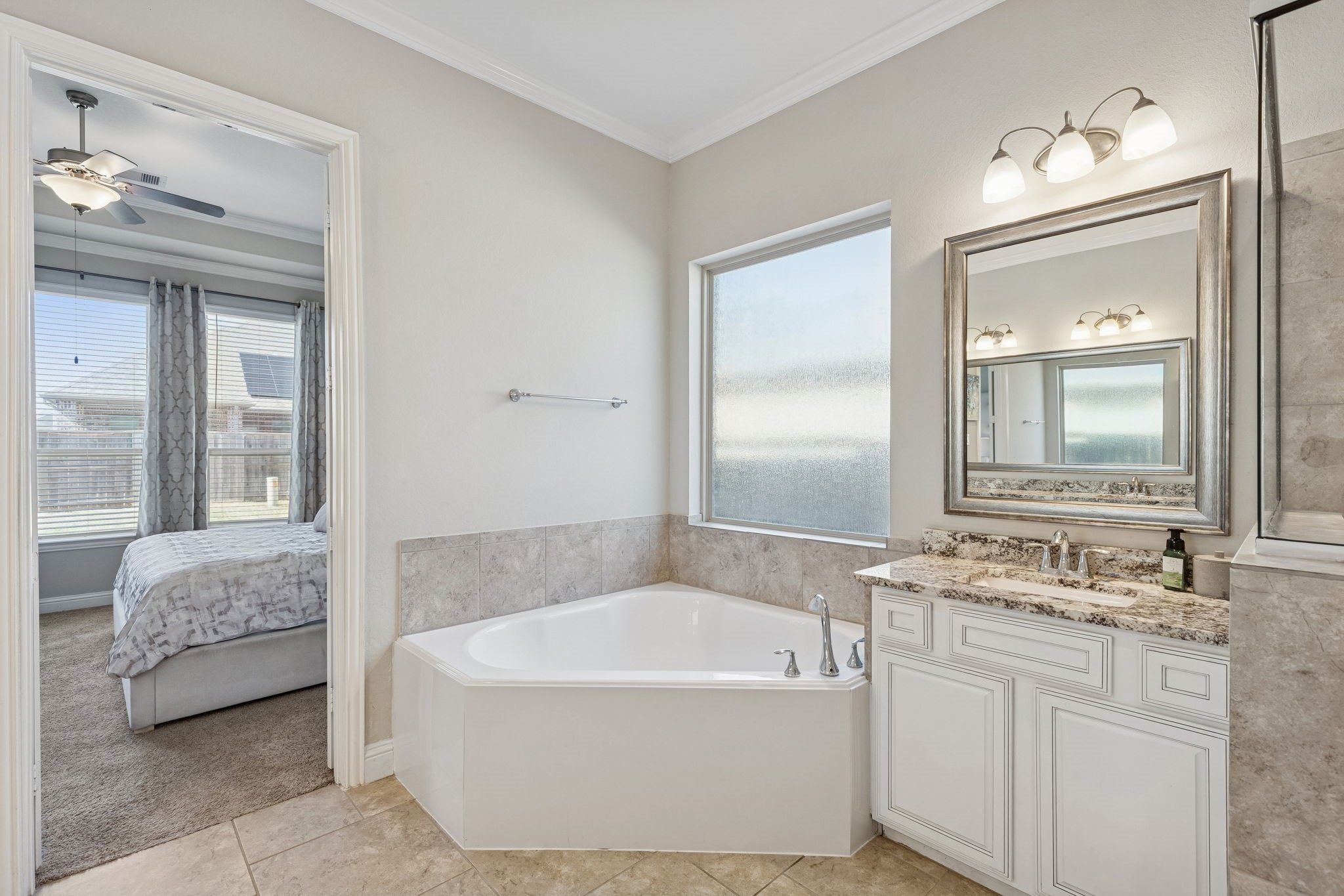 1619 Dove Ridge Drive Katy, TX 77493 - Photo 10 of 28 The Primary Bath is a true sanctuary, featuring a deep corner soaking tub and elegant granite-topped dual vanities.