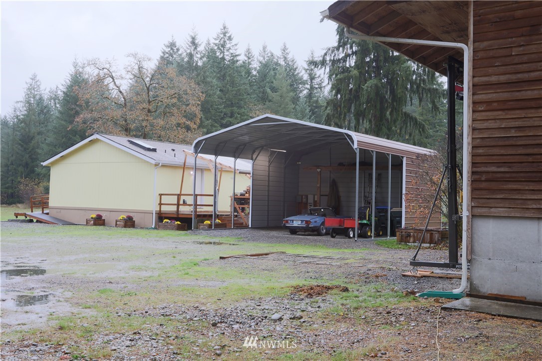 10046 168th Avenue Southwest Rochester, WA 98579 - Photo 2 of 33 a view of a house with backyard and sitting area