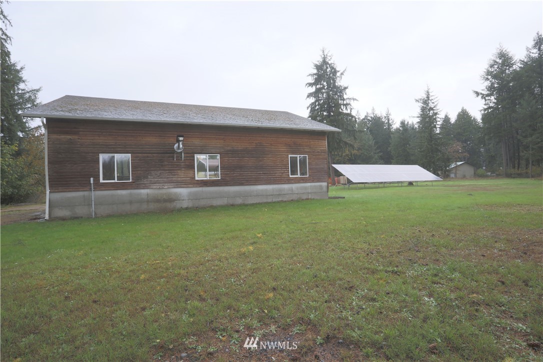 10046 168th Avenue Southwest Rochester, WA 98579 - Photo 27 of 33 a front view of a house with a yard and trees