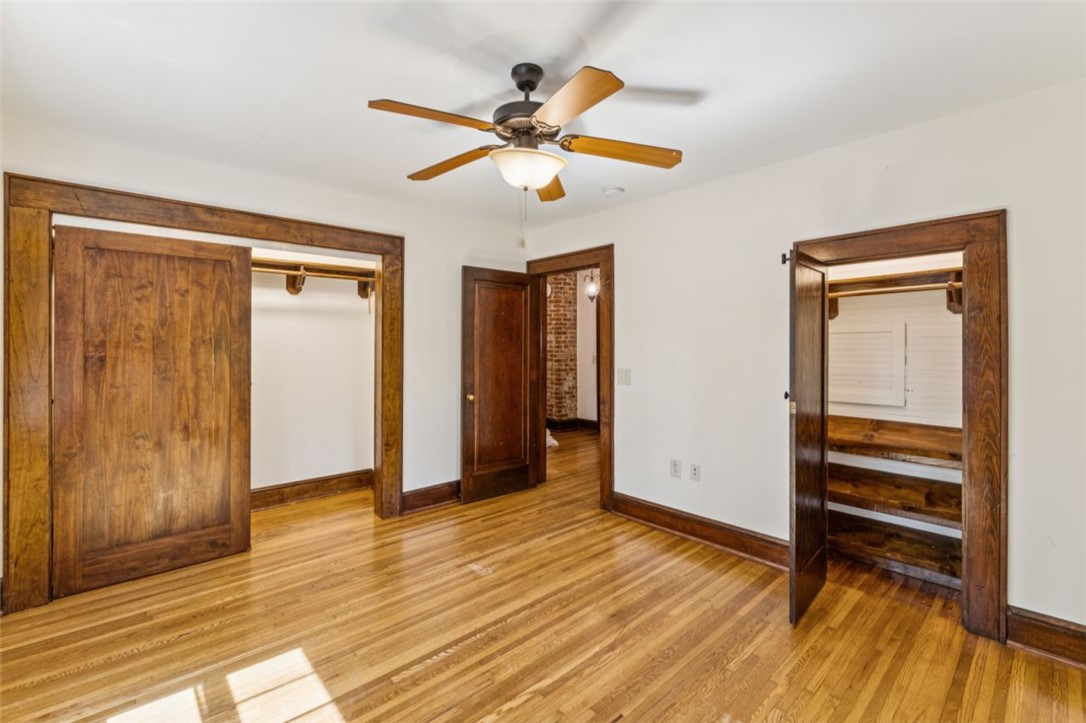 321 South Pine Street Walhalla, SC 29691 - Photo 29 of 32 Hardwood floors and rich wooden trim highlight the spaciousness of this bedroom.