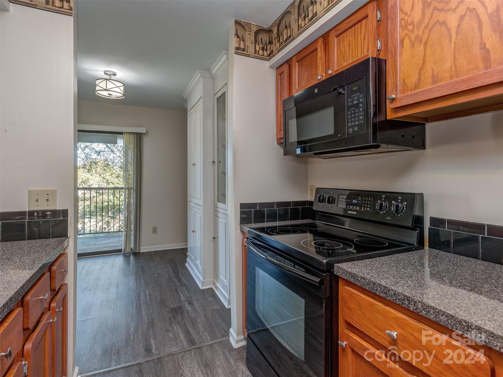 11014 Cedar View Road Charlotte, NC 28226 - Photo 12 of 32 a kitchen with granite countertop a stove and a microwave