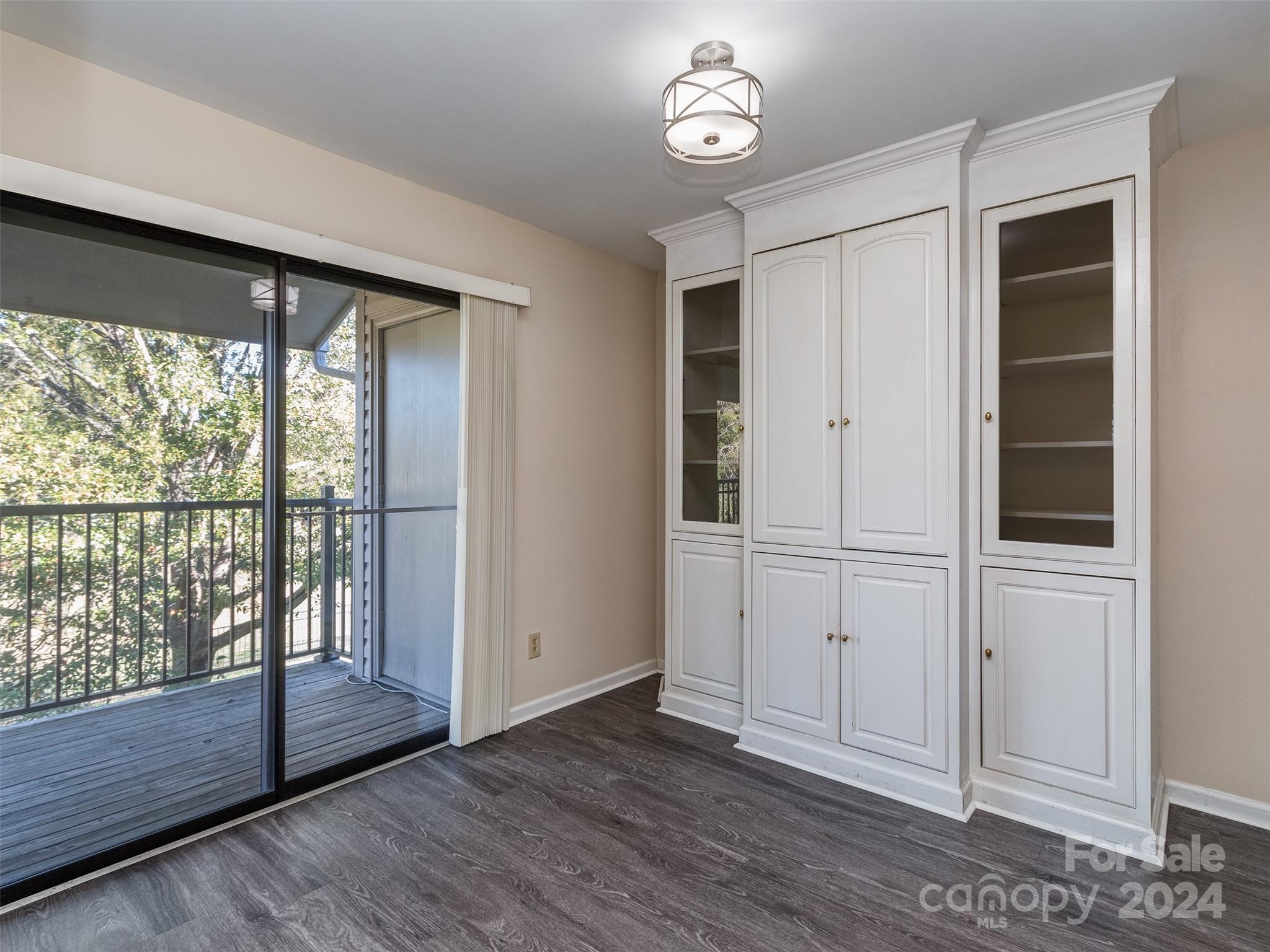 11014 Cedar View Road Charlotte, NC 28226 - Photo 14 of 32 an empty room with wooden floor and windows