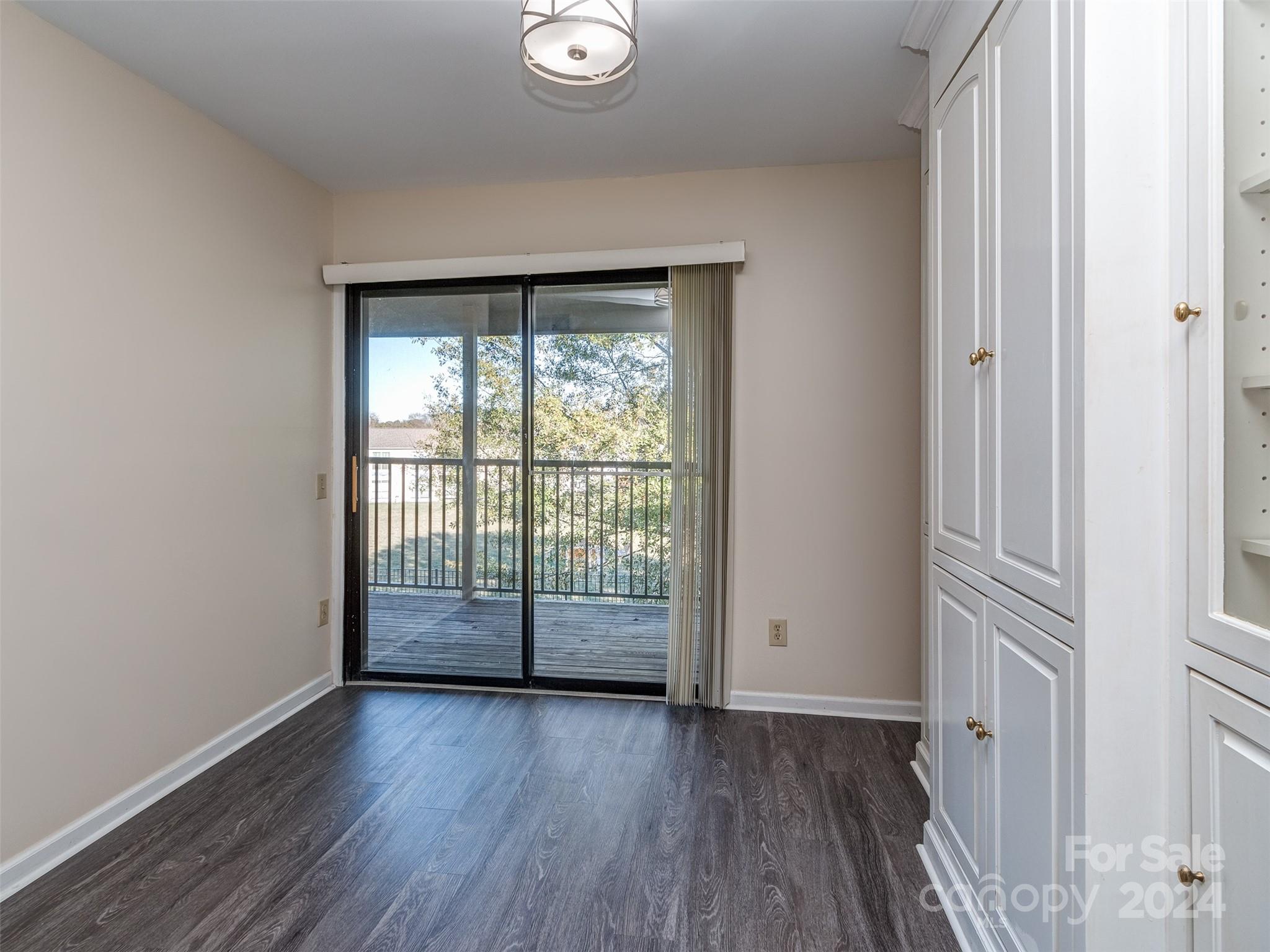 11014 Cedar View Road Charlotte, NC 28226 - Photo 15 of 32 wooden floor in an empty room with a window